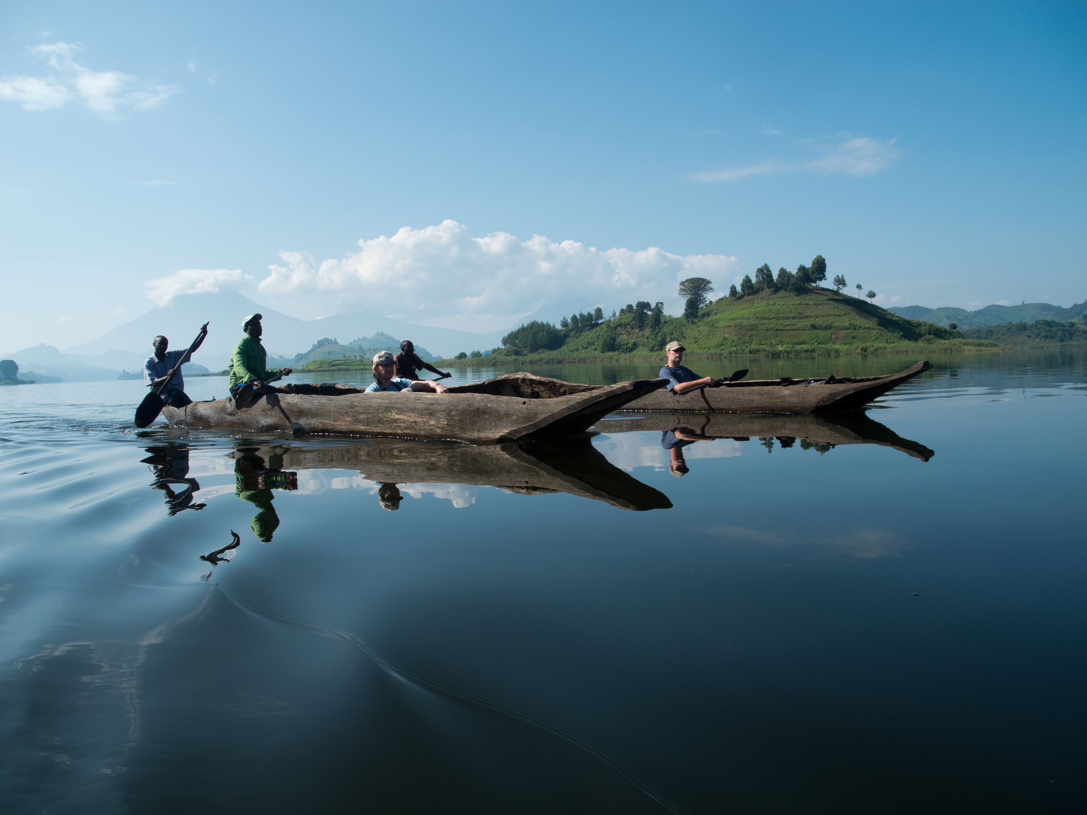 Canoeing on Lake Mutanda beneath the Virunga volcanoes in Uganda